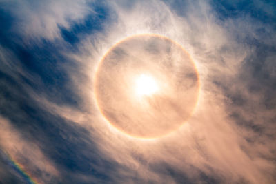 Low angle view of sun shining in sky