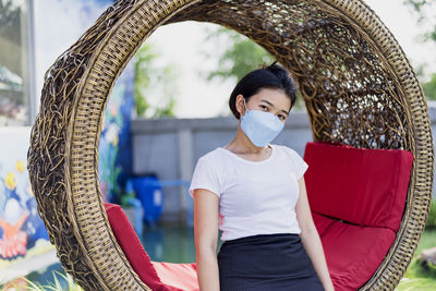 Asian girl wearing a mask detained and happy at home ,stay home away from society.