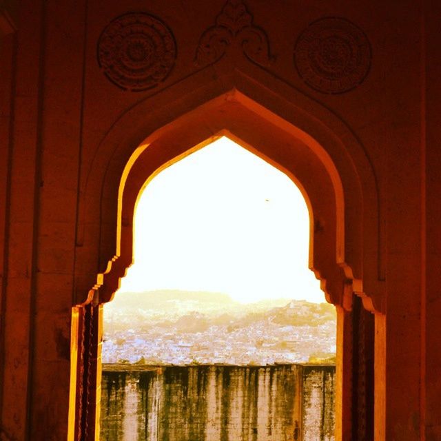 indoors, arch, built structure, architecture, window, door, religion, sunlight, mountain, no people, church, spirituality, sky, house, day, place of worship, low angle view, entrance, history