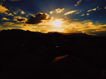 Scenic view of silhouette mountains against sky during sunset