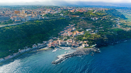 Timpa di acireale aerial view from above on santa maria la scala with sea and blue sky