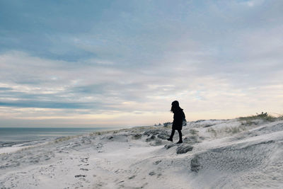 Full length of man standing on snow covered land