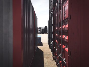 Cargo containers at dock against clear sky