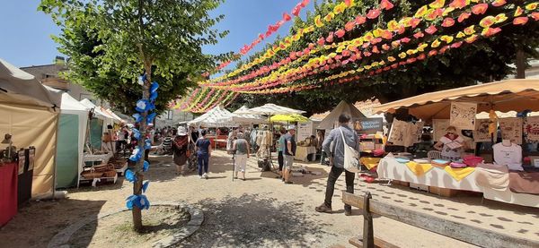 People at market against buildings