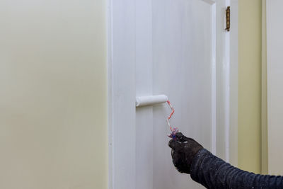 Man painting door at home