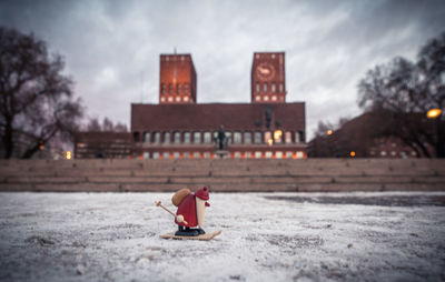 Figurine on snow covered field