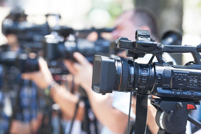 Men operating camera during event