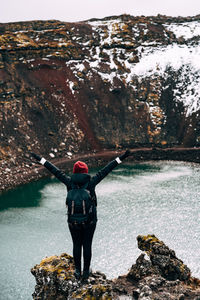 Rear view of man standing on rock