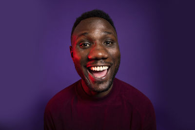 Portrait of a smiling man against blue background