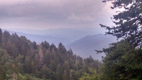 Scenic view of mountains against cloudy sky