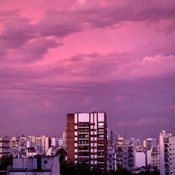 High angle view of illuminated buildings against dramatic sky