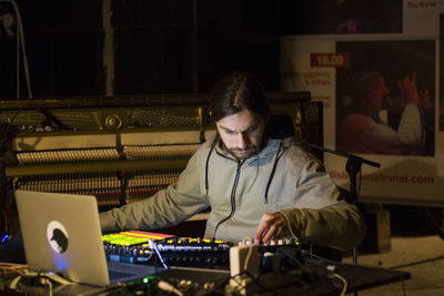 Young man working at music concert