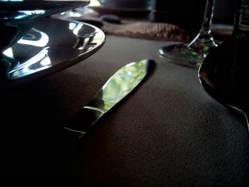 Close-up of illuminated lamp on table