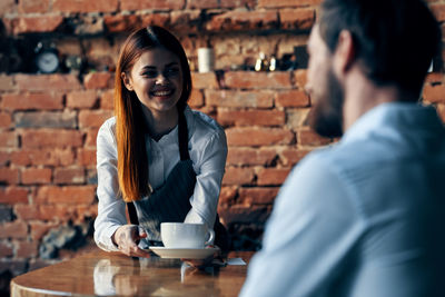 Portrait of smiling young woman with coffee