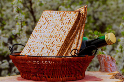 Crackers with wine bottle in wicker basket