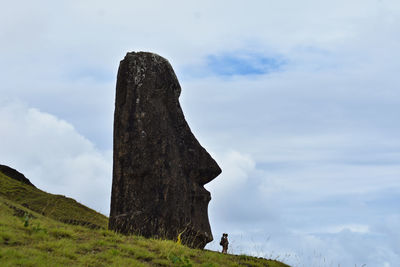 Low angle view of person on land against sky
