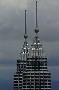 Low angle view of building against cloudy sky