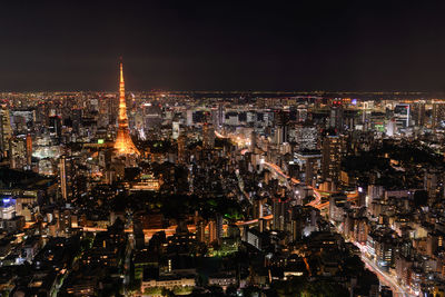 High angle view of city lit up at night