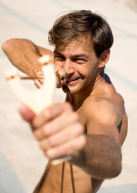 Close-up of young man holding camera