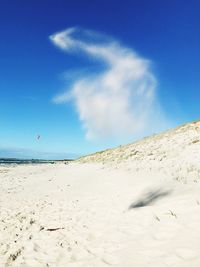 Scenic view of beach against blue sky