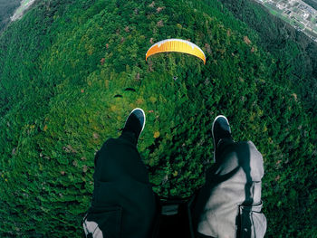 Low section of men paragliding
