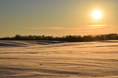 Scenic view of snow covered landscape during sunset