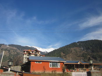 Houses and mountains against sky