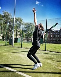 Woman playing soccer on field