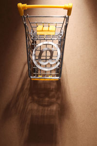 High angle view of illuminated lamp on table against wall