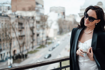 Young woman wearing sunglasses standing outdoors