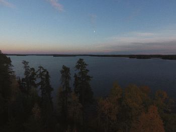 Scenic view of lake against sky at sunset