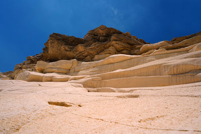 Low angle view of rock formations in desert against sky