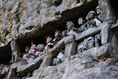 Low angle view of statues on rock