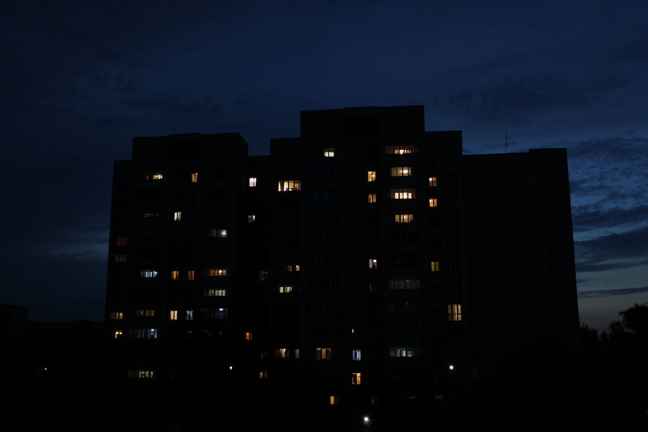 LOW ANGLE VIEW OF BUILDINGS AGAINST SKY AT NIGHT