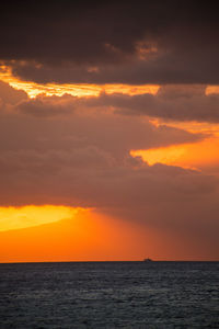 Scenic view of sea against romantic sky at sunset