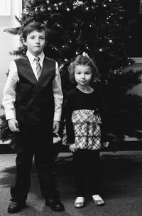 Portrait of siblings standing outdoors