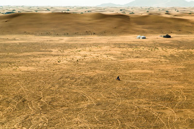 Scenic view of desert on field against sky