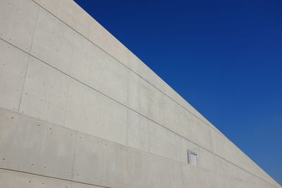 Low angle view of built structure against clear blue sky