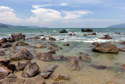 Rocks on beach against sky