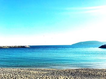 Scenic view of sea against clear blue sky