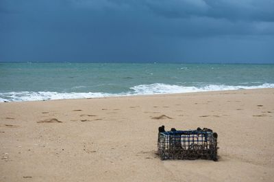 Lifeguard hut on beach against sky