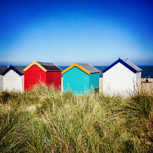 Beach huts in the sand dunes at southwold, suffolk.