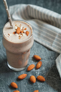 Close-up of drink with almonds on table