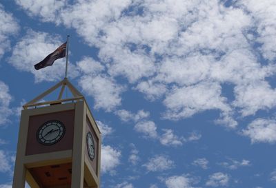 Low angle view of clock tower against cloudy sky