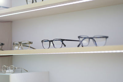 Close-up of eyeglasses on shelves in store