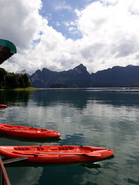 Boat moored in lake against sky