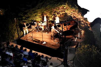 High angle view of people standing on illuminated stage at night