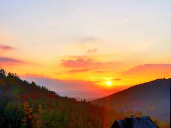 Scenic view of silhouette landscape against romantic sky at sunset