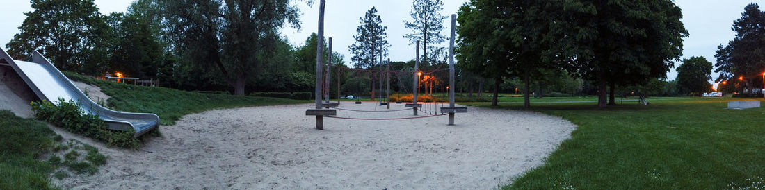 Trees in park against sky during winter