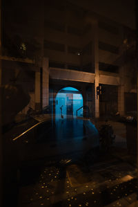 Car seen through window by building at night